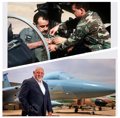 A man standing next to an airplane and another man in military fatigues.