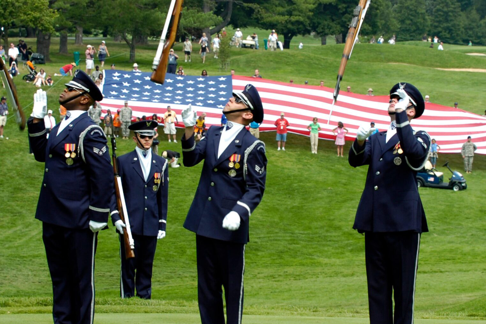 A group of men in uniform holding flags.